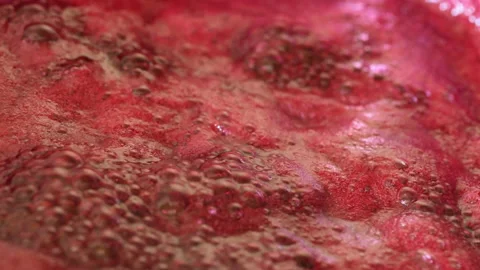 Boiling black currant jam in a saucepan close up Video stock 136601432