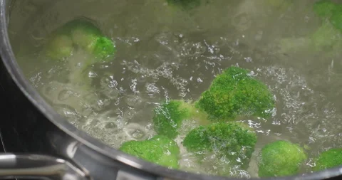 Boiling broccoli in a pot on induction stove. Vegetarian, healthy food concept Stock Footage 250222724
