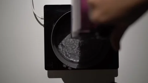 Boiling broccoli in a pot on small Induction Cooktop. Stock Footage 256932151