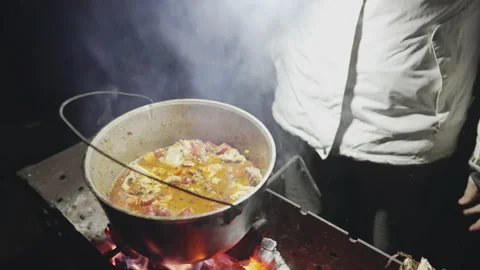 Boiling broth with ingredients is cooked on the grill Stock Footage 231712786