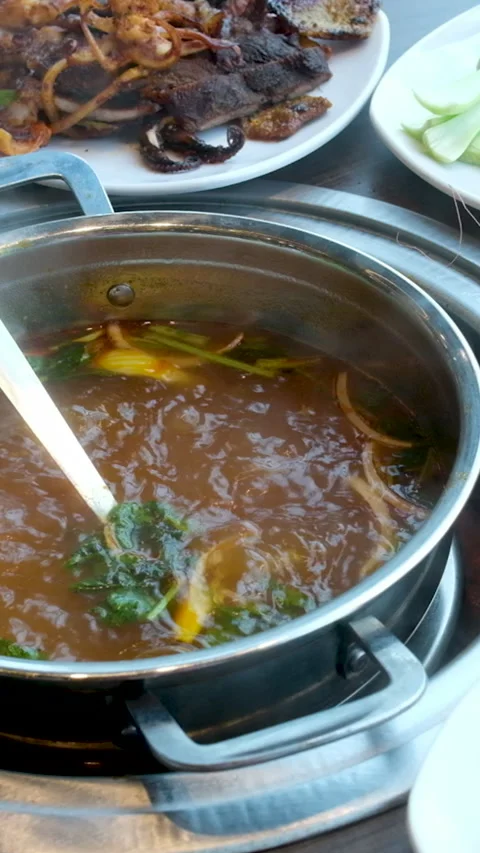 Boiling broth live cooking lamb stew in central java Indonesia with sweet soy Stock Footage 282077665