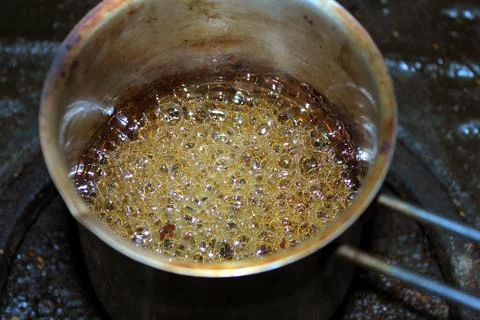 Boiling with bubbling liquid in a saucepan Stock Photos