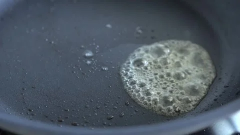 Boiling butter in a frying pan. Stock Footage 341387509