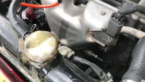 Boiling car radiator with foam and water overflowing, engine overheating Stock Footage 328214844