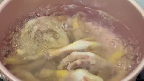 Boiling chicken feet in a pot Stock Footage 324749045