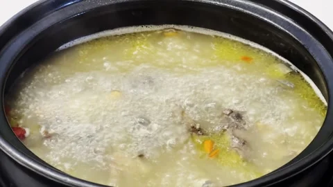 Boiling Chicken Soup in Black Pot - Traditional Chinese Cooking 4K Stock Footage 340131682