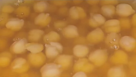 Boiling Chickpeas in Bubbling Golden Broth Video Clip Video stock 331765182