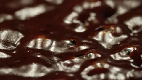 Boiling chocolate. Macro shot of thick brown liquid, shallow depth of field. Stock Footage 163120300