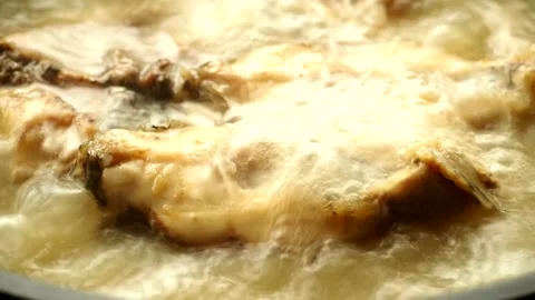 Boiling chopped Tilapia fish in pot, in door Chiangmai Thailand. Stock Footage 252825006