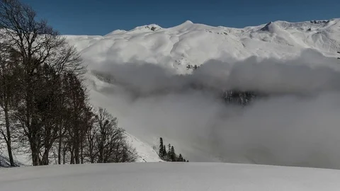 Boiling Clouds. Snow covered mountains.  Panorama. Time lapse Stock-Footage 83691122