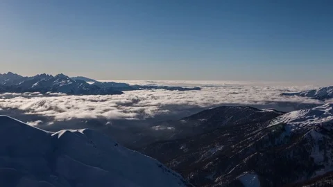 Boiling clouds in winter mountain valley. Zoom in time lapse Stock Footage 83690579