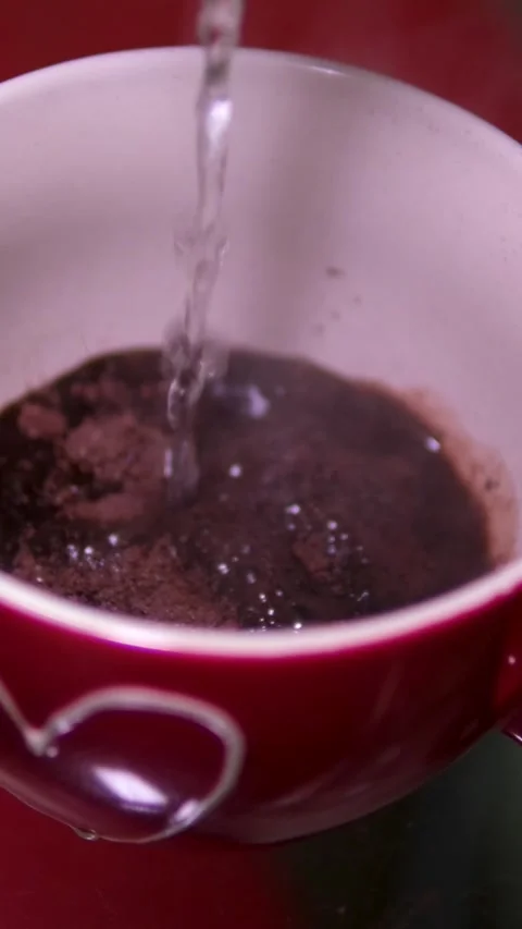 Boiling cocoa water Close Up Of Slow Motion Pour Chocolate Milk Drink In Tumbler Stock-Footage 305981319