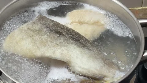 Boiling cod fish in water in iron pot Video stock 334187979