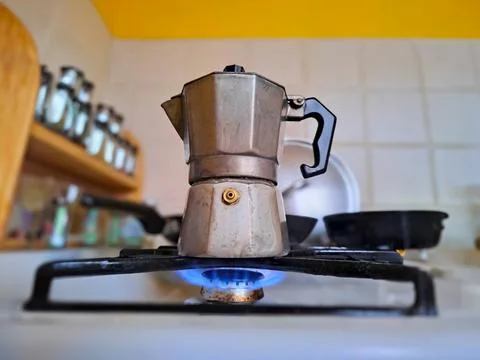 Boiling Coffee on gas in kitchen. Moka pot, italian traditional coffee maker Stock Photos