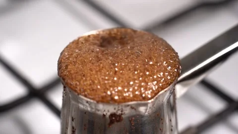 Boiling coffee while preparation in turkish coffee pot Stock Footage 145265574