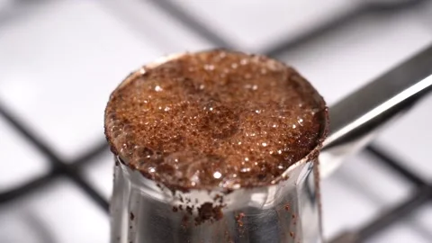 Boiling coffee while preparation in turkish coffee pot Stock Footage 148976585