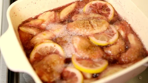 Boiling compote with figs, sliced lemon, red wine and sugar in ceramic pot Stock Footage 114646681