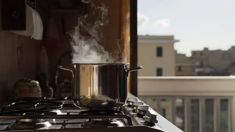 Boiling cooking pan on heating stove on balcony background. Gas flame heating 스톡 동영상 117353371