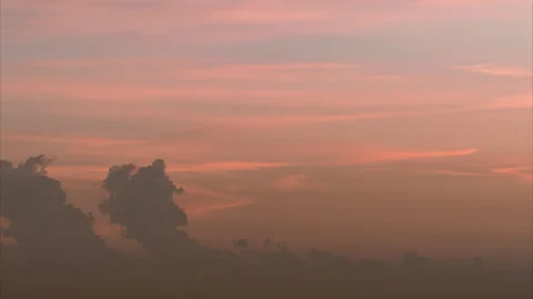 Boiling cumulus clouds shooting up and down on the sunset cityscape background 스톡 동영상 258845231