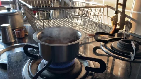 Boiling cup of tea on a stove Stock Footage 226134806