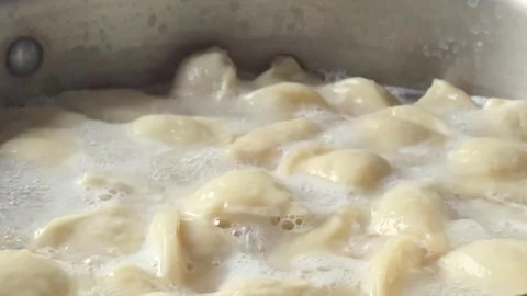 Boiling Dumplings Actively Bubbling in a Pot of Water 動画素材 345454016