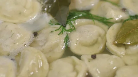 Boiling dumplings with meat in boiling water. Stock-Footage 163758320