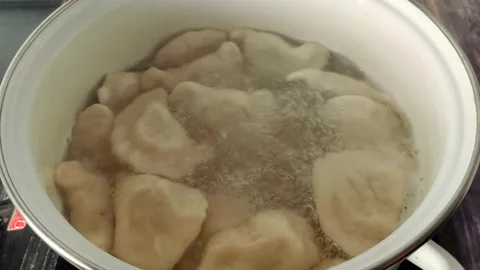 Boiling dumplings with potatoes in a pot of boiling water Stock Footage 232219364