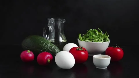 Boiling egg tomatoes avocado arugula olive oil radish sesame seeds Stock Footage 106874076