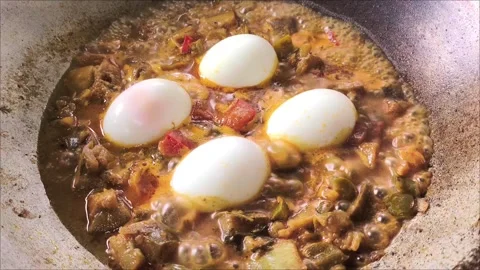 Boiling eggs with curry in pan, in door Chiangmai Thailand. Stock Footage 295334424