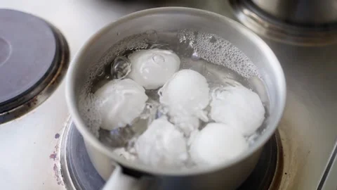 Boiling Eggs Effectively in a Pot on the Stove A Simple Cooking Method for Video stock 304684060