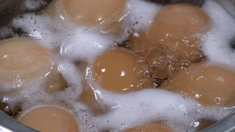 Boiling eggs in a metal saucepan Stock-Footage 88256846