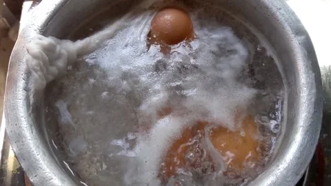 Boiling eggs in a pot Stock Footage