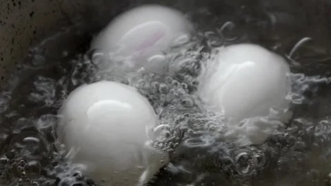 Boiling eggs in a pot of water on the stove Stock Footage 337143701