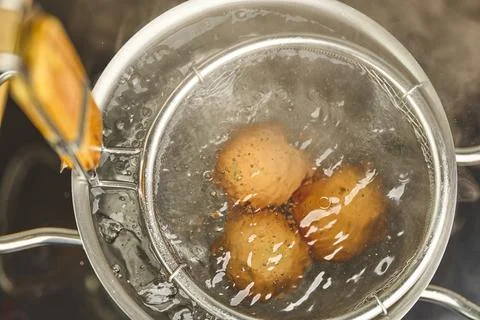 Boiling eggs in ramen pot with hot water Stock Photos