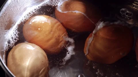 Boiling eggs in a saucepan for breakfast Stock Footage 221940067