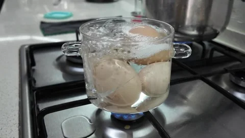 Boiling Eggs in Transparent Glass Pot on Gas Stove Vídeo Stock 331564296