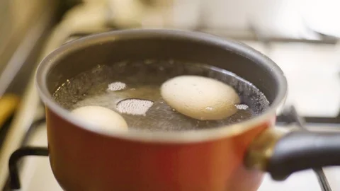 Boiling Egss in a brown pot Stock Footage 106759021