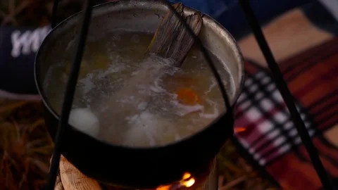 Boiling fish soup on the fire. Slow motion Stock Footage 82213542