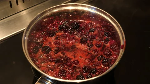 Boiling fresh blackberries to make jam. Stock Footage 218257150