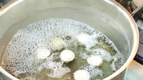 Boiling fresh straw mushrooms in a hot herbal soup pot. Stock Footage 342393574