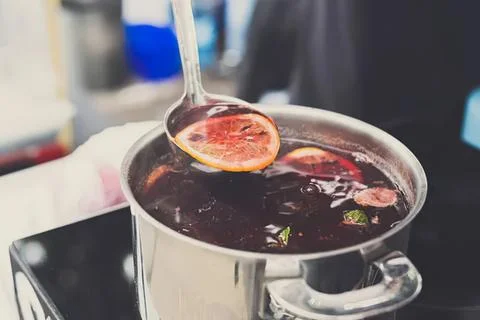 Boiling fruit tea with slices in a pot on stove Stock Photos