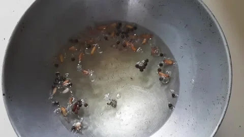 Boiling Garlic and Black Pepper in Oil for Homemade Pickle Preparation Stock Footage 337352863