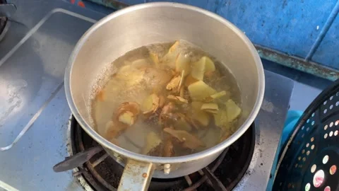 Boiling ginger in a hot pot at home kitchen. Healthy lifestyle concept Stock Footage 268169324