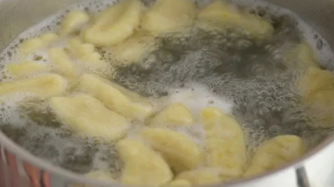 Boiling gnocchi in a sauce pan. Stock Footage 153405084
