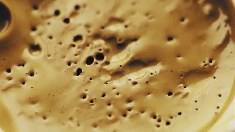 Boiling golden dye sequence Stock Footage 81016079