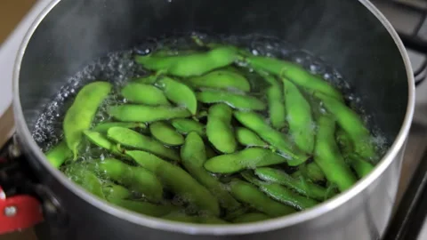 Boiling green edamame soybeans in a pot. 4K Close-up. Stock Footage 328629392