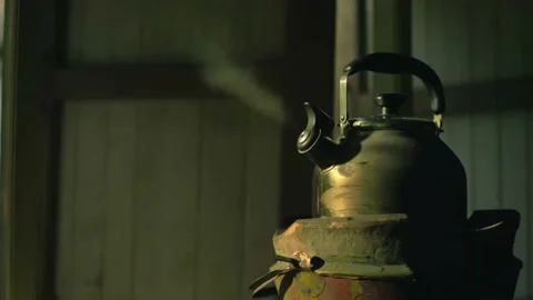 Boiling green kettle boiling with steam emitted from spout. kitchen window. Stock Footage 235880651