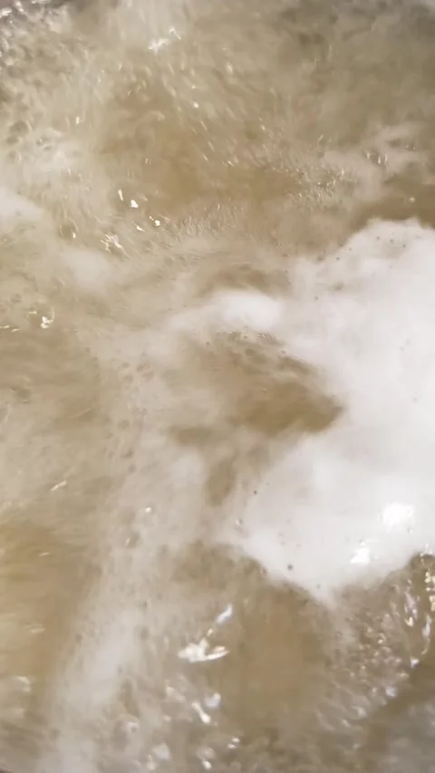 Boiling Hot Broth Bubbling Vigorously with Thick White Foam Close Up Stock Footage 339084456