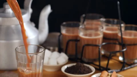 Boiling hot flavored tea pouring in transparent glass - refreshing hot  drink... Video stock 157303685