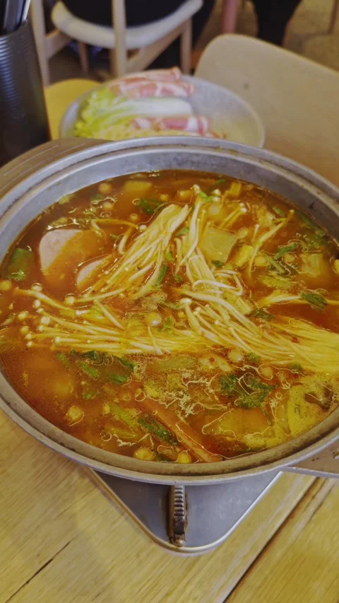 Boiling Hot Pot with Enoki Mushrooms and Vegetables Stock Footage 314985174